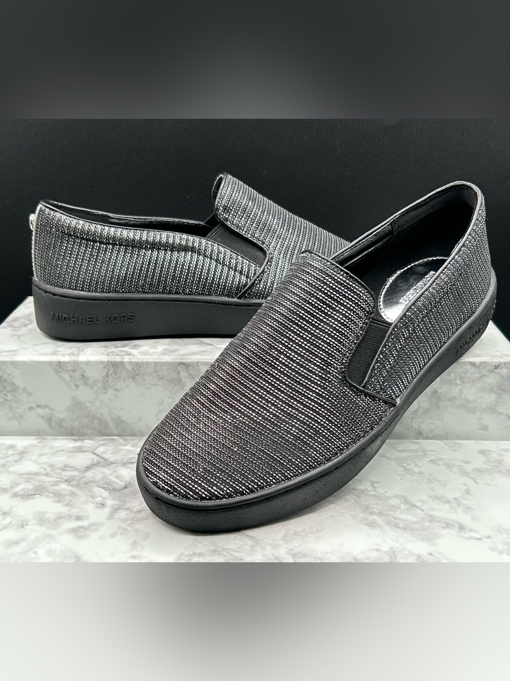 M. MICHAEL KORS Keaton Slip-On Sneakers in Black and Silver Glitter Mesh. Size 6
